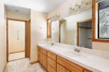 This bathroom boasts dual sinks with ample counter space, perfect for a busy morning routine.