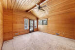 This spacious room boasts a stunning wood-paneled ceiling and walls, creating a warm and inviting atmosphere.