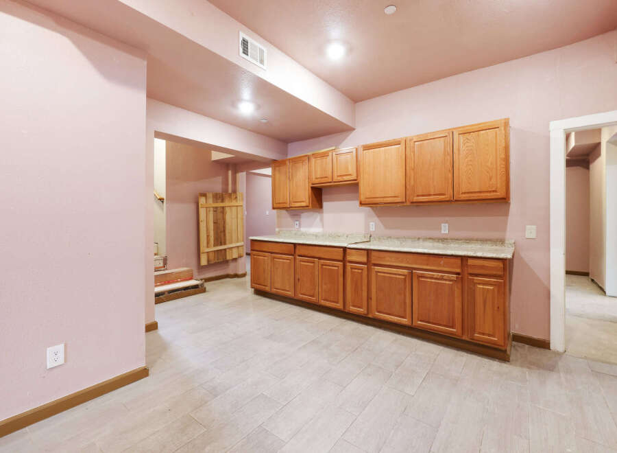 This newly remodeled kitchen boasts beautiful light wood cabinets and granite countertops, creating a bright and airy atmosphere.
