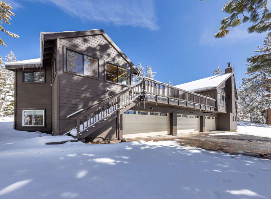 This stunning mountain home boasts a spacious three-car garage, perfect for storing all your outdoor gear.