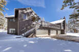 This stunning mountain home boasts a spacious three-car garage, perfect for storing all your outdoor gear.