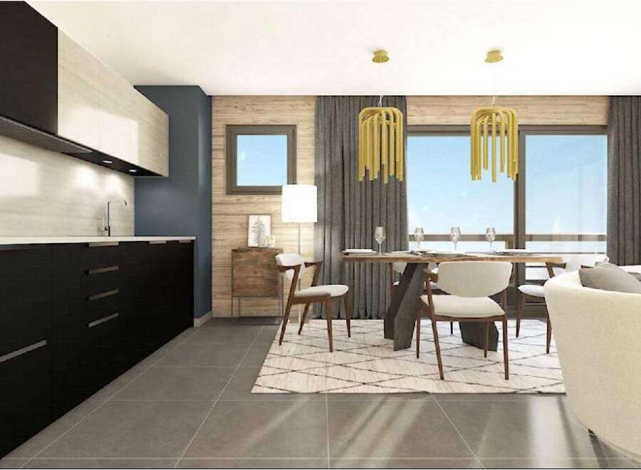 Stunning modern apartment boasts an open-plan kitchen with sleek black cabinetry and integrated appliances.