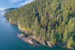 Discover this breathtaking waterfront property nestled amidst a lush evergreen forest.
