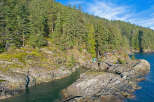Secluded waterfront property nestled amongst lush evergreen forest.