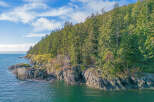 Discover this breathtaking waterfront property nestled amidst lush evergreen forests.