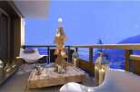 Cozy balcony with stunning mountain views, perfect for enjoying a winter evening.