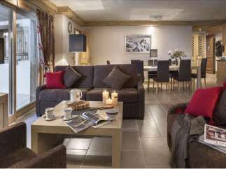 This stunning apartment boasts a spacious living area with comfortable seating, perfect for relaxing after a day on the slopes.