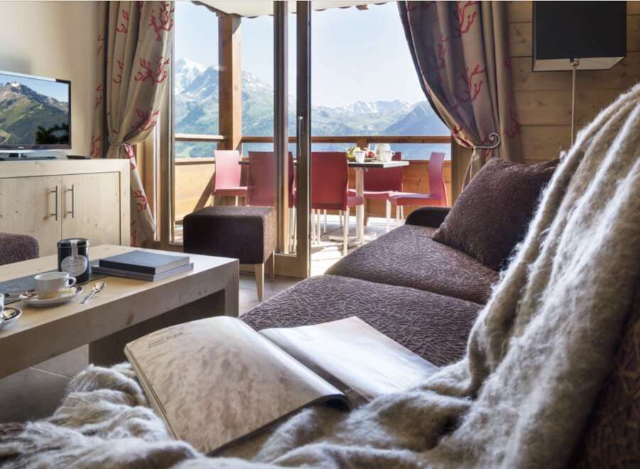 This luxurious apartment boasts breathtaking mountain views from its spacious living area.