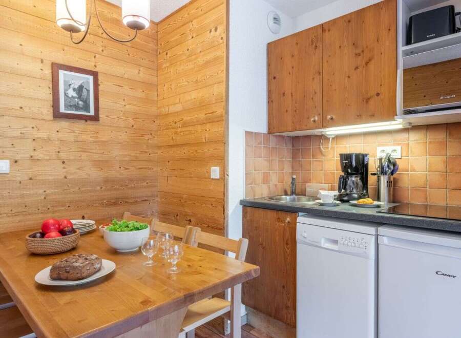 Cozy chalet apartment featuring a fully equipped kitchen with modern appliances, including a dishwasher.