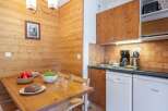 Cozy chalet apartment featuring a fully equipped kitchen with modern appliances, including a dishwasher.