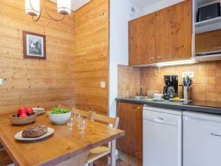 Cozy chalet apartment featuring a fully equipped kitchen with modern appliances, including a dishwasher.