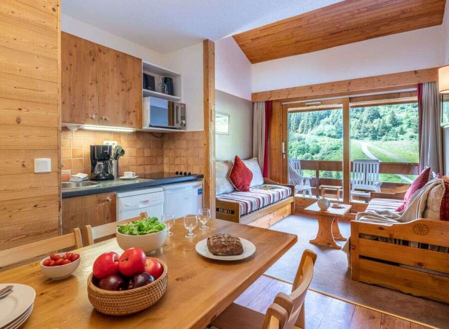 Cozy chalet apartment with fully equipped kitchen and dining area.