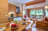 Cozy chalet apartment with fully equipped kitchen and dining area.