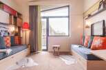 Cozy apartment featuring built-in storage, comfortable sofa beds, and a large window offering stunning mountain views.