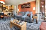 Cozy apartment featuring a well-equipped kitchen, comfortable living area with sofa and dining space.