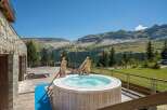 Luxury chalet with stunning mountain views and private hot tub.