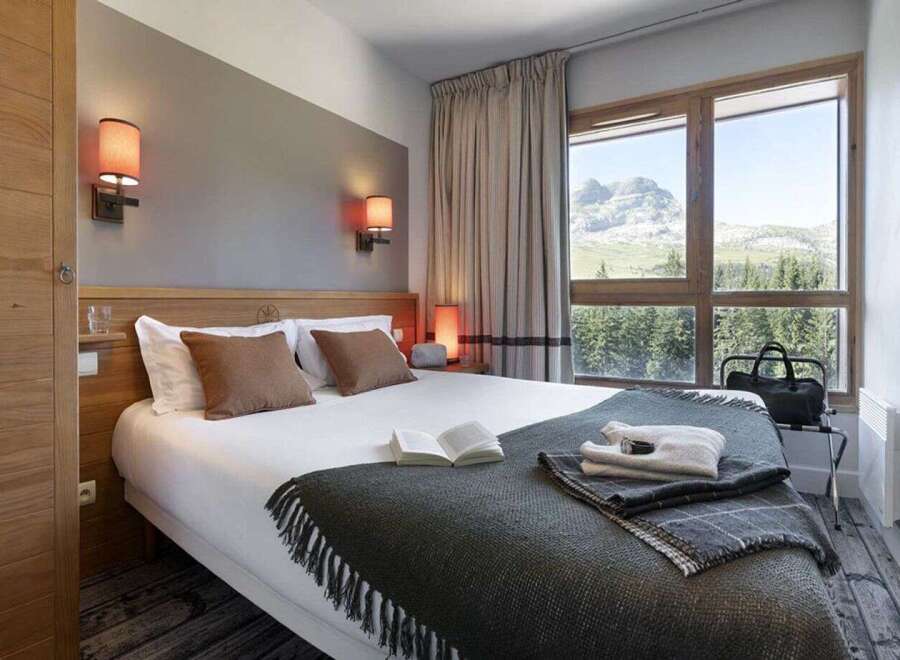 Wake up to breathtaking mountain views from this cozy hotel room.
