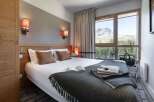 Wake up to breathtaking mountain views from this cozy hotel room.