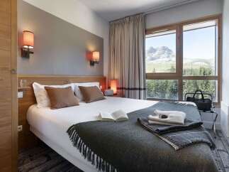 Wake up to breathtaking mountain views from this cozy hotel room.
