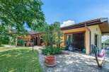 This stunning property boasts a spacious patio perfect for outdoor entertaining, complete with a built-in dining area and lush landscaping.