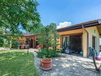 This stunning property boasts a spacious patio perfect for outdoor entertaining, complete with a built-in dining area and lush landscaping.