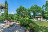 This stunning property boasts a luxurious outdoor space, complete with a hammock for relaxation and a refreshing swimming pool.
