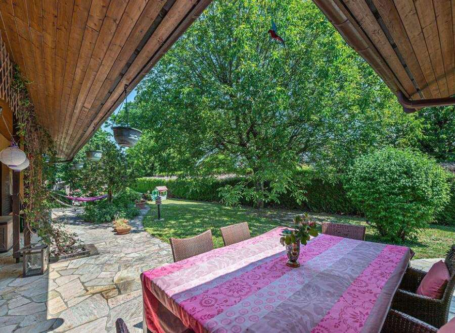 This charming property boasts a spacious patio perfect for outdoor dining, complete with a picturesque garden view.