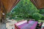 This charming property boasts a spacious patio perfect for outdoor dining, complete with a picturesque garden view.
