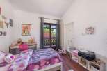 Charming bedroom with balcony access, showcasing a lovely view.