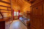 Cozy chalet bedroom with wooden bunk beds, perfect for families or groups.