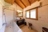 This luxurious bathroom boasts a spacious bathtub, double sinks, and a walk-in shower, perfect for relaxation.