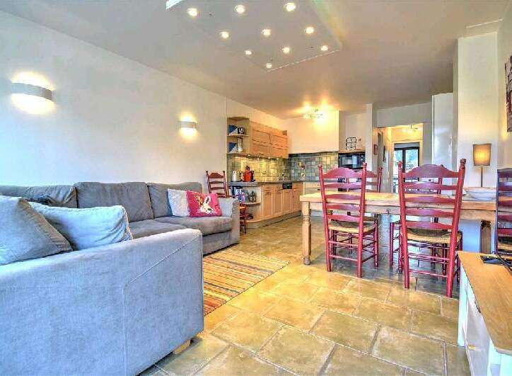 This stunning apartment boasts an open-plan living area with a comfortable sofa and a fully equipped kitchen.