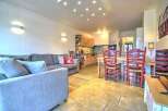 This stunning apartment boasts an open-plan living area with a comfortable sofa and a fully equipped kitchen.
