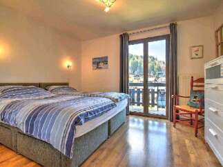 This charming bedroom boasts a comfortable double bed with crisp linens, perfect for a relaxing stay.