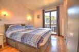 Cozy bedroom with a comfortable double bed and stunning mountain views.