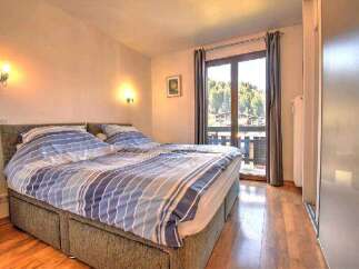 Cozy bedroom with a comfortable double bed and stunning mountain views.