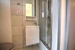 Modern bathroom with a walk-in shower, stylish vanity, and contemporary tile.
