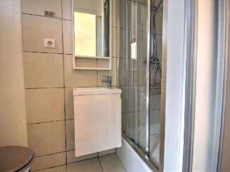 Modern bathroom with a walk-in shower, stylish vanity, and contemporary tile.