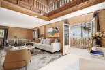 This stunning chalet boasts a spacious open-plan living area with high ceilings and large windows offering abundant natural light.