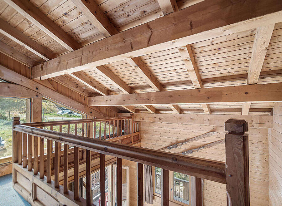 This stunning chalet boasts a magnificent wooden interior with exposed beams and a spacious open-plan living area.