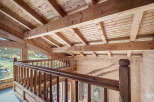 This stunning chalet boasts a magnificent wooden interior with exposed beams and a spacious open-plan living area.