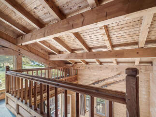 This stunning chalet boasts a magnificent wooden interior with exposed beams and a spacious open-plan living area.