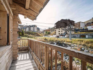 This charming wooden chalet boasts a private balcony offering breathtaking views of the Tignes ski resort.