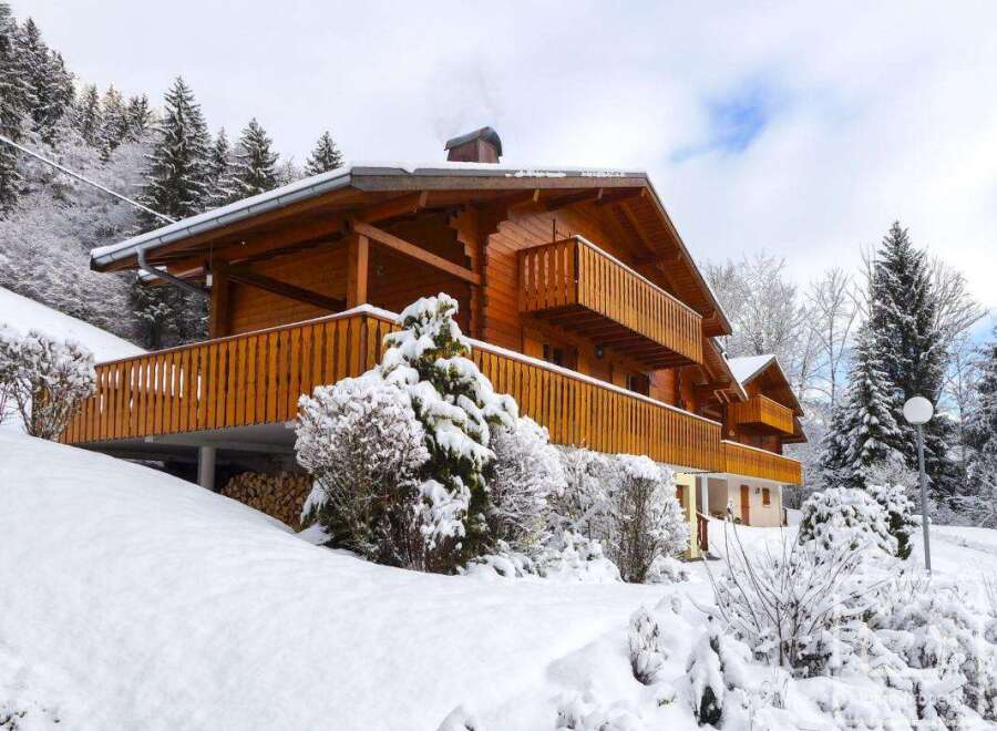 This stunning chalet boasts a beautiful wooden exterior, spacious balconies perfect for enjoying mountain views, and a cozy interior ideal for a winter getaway.