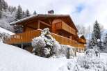 This stunning chalet boasts a beautiful wooden exterior, spacious balconies perfect for enjoying mountain views, and a cozy interior ideal for a winter getaway.