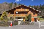This stunning chalet boasts a spacious wooden exterior, two balconies offering breathtaking views, and a convenient attached garage.
