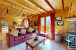 This charming chalet boasts a spacious open-plan living area with a wood-burning stove, creating a cozy atmosphere.
