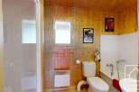 This charming bathroom boasts a delightful combination of rustic wood paneling and modern amenities.