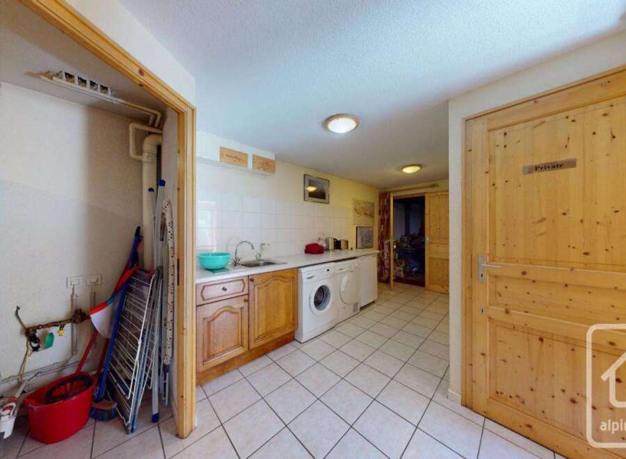 This stunning property boasts a spacious laundry room complete with washer, dryer, and ample storage.