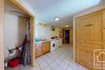 This stunning property boasts a spacious laundry room complete with washer, dryer, and ample storage.